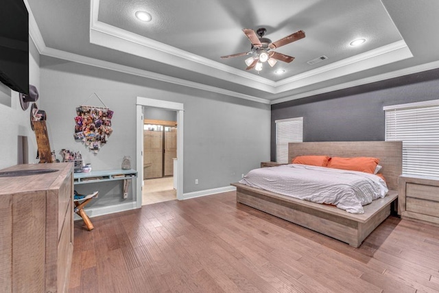 1315 W Magnolia St, Rogers, AR 72758 - bedroom with a raised ceiling, crown molding, wood finished floors, recessed lighting, and ensuite bath
