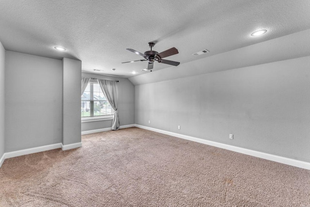 1315 W Magnolia St, Rogers, AR 72758 - carpeted spare room featuring a textured ceiling, ceiling fan, vaulted ceiling, and recessed lighting