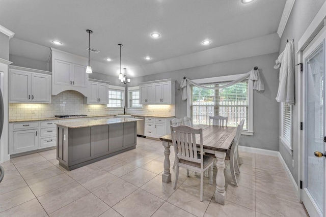 1315 W Magnolia St, Rogers, AR 72758 - kitchen featuring backsplash, stainless steel appliances, white cabinets, a kitchen island, and light tile patterned floors