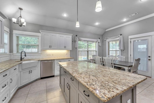 1315 W Magnolia St, Rogers, AR 72758 - kitchen with stainless steel dishwasher, a chandelier, tasteful backsplash, light tile patterned flooring, and a kitchen island