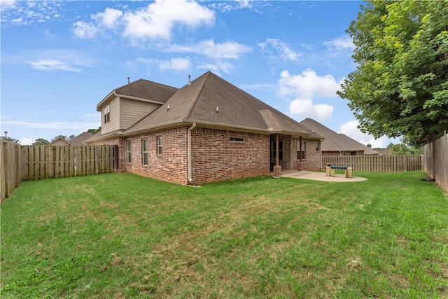 1315 W Magnolia St, Rogers, AR 72758 - back of property featuring brick siding, a patio area, a fenced backyard, and roof with shingles