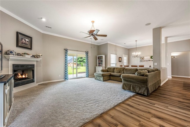 372 Niagara St, Elm Springs, AR 72762 - living room featuring a ceiling fan, a glass covered fireplace, a chandelier, wood finished floors, and ornamental molding