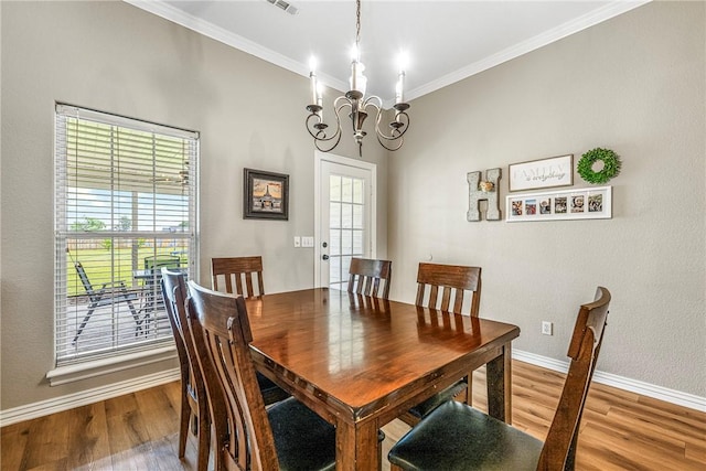 372 Niagara St, Elm Springs, AR 72762 - dining room with wood finished floors, crown molding, and a chandelier