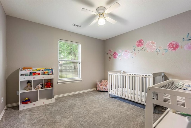 372 Niagara St, Elm Springs, AR 72762 - carpeted bedroom featuring a crib and a ceiling fan