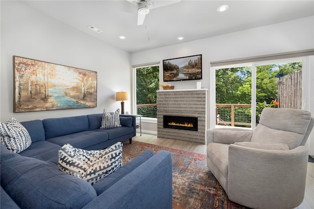 239 N Fletcher Ave, Fayetteville, AR 72701 - living area featuring wood finished floors, healthy amount of natural light, a brick fireplace, a ceiling fan, and recessed lighting