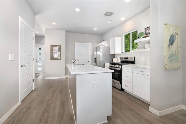 239 N Fletcher Ave, Fayetteville, AR 72701 - kitchen featuring appliances with stainless steel finishes, wood finished floors, white cabinets, and recessed lighting