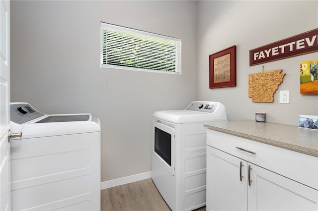 239 N Fletcher Ave, Fayetteville, AR 72701 - laundry room with separate washer and dryer, light wood-style floors, and cabinet space