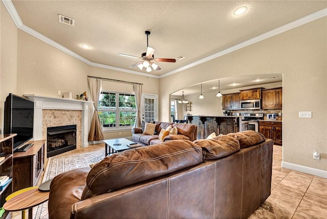 4300 Limestone Ave, Bentonville, AR 72712 - living area with ceiling fan, ornamental molding, a textured ceiling, a tile fireplace, and light tile patterned floors