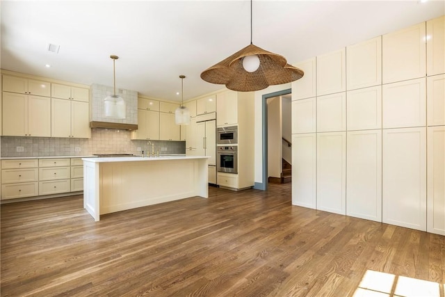 302 NW 5th St, Bentonville, AR 72712 - kitchen featuring stainless steel oven, light countertops, wood finished floors, decorative backsplash, and stovetop