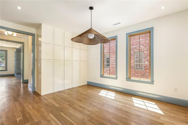 302 NW 5th St, Bentonville, AR 72712 - unfurnished dining area featuring wood finished floors and recessed lighting