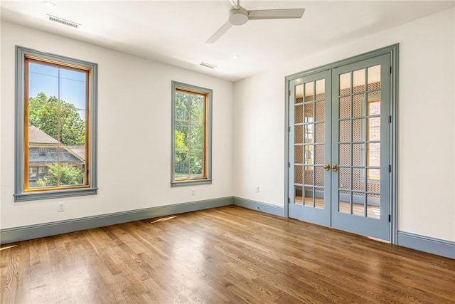 302 NW 5th St, Bentonville, AR 72712 - unfurnished room featuring french doors, wood finished floors, and ceiling fan