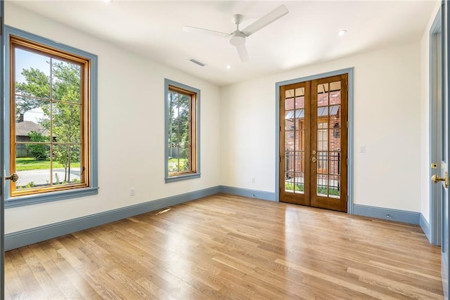 302 NW 5th St, Bentonville, AR 72712 - unfurnished room featuring french doors, plenty of natural light, ceiling fan, wood finished floors, and recessed lighting