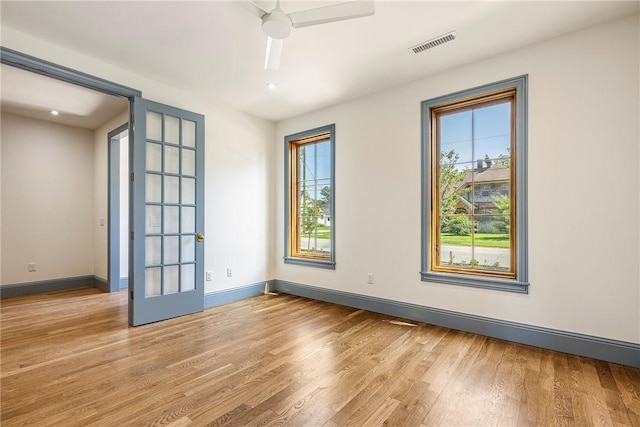 302 NW 5th St, Bentonville, AR 72712 - unfurnished room featuring wood finished floors, french doors, a ceiling fan, and recessed lighting
