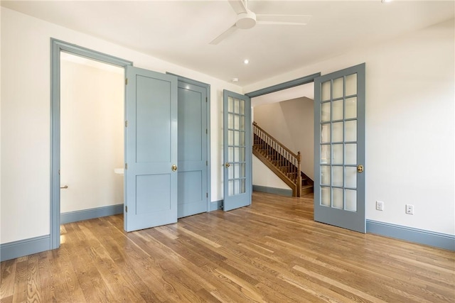 302 NW 5th St, Bentonville, AR 72712 - spare room featuring french doors, wood finished floors, and a ceiling fan