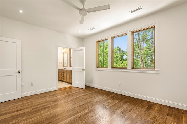 302 NW 5th St, Bentonville, AR 72712 - unfurnished bedroom with light wood-type flooring, ensuite bathroom, a ceiling fan, and recessed lighting