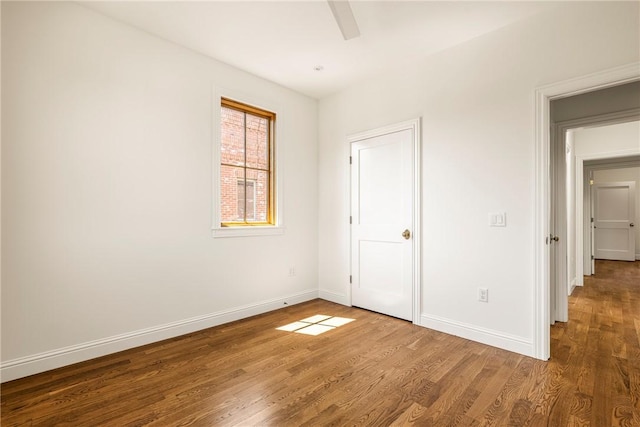 302 NW 5th St, Bentonville, AR 72712 - unfurnished bedroom featuring wood finished floors and ceiling fan