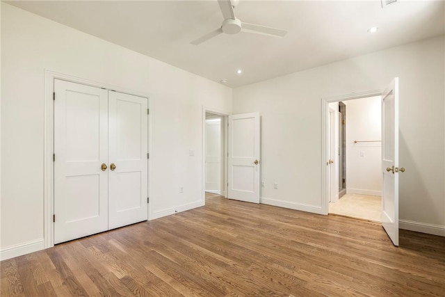 302 NW 5th St, Bentonville, AR 72712 - unfurnished bedroom featuring light wood-style floors, a closet, a ceiling fan, and recessed lighting
