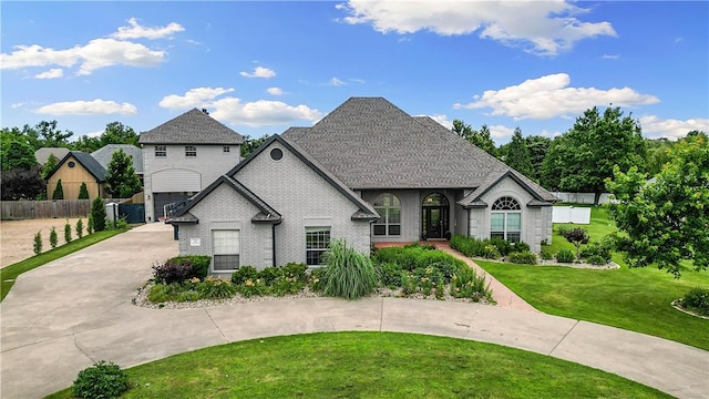 11 Darian Dr, Bentonville, AR 72712 - french country style house with curved driveway, brick siding, and an attached garage