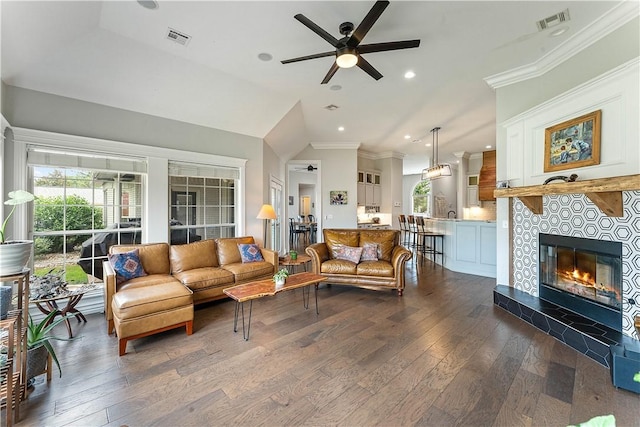 11 Darian Dr, Bentonville, AR 72712 - living area with a ceiling fan, dark wood finished floors, ornamental molding, recessed lighting, and a tile fireplace