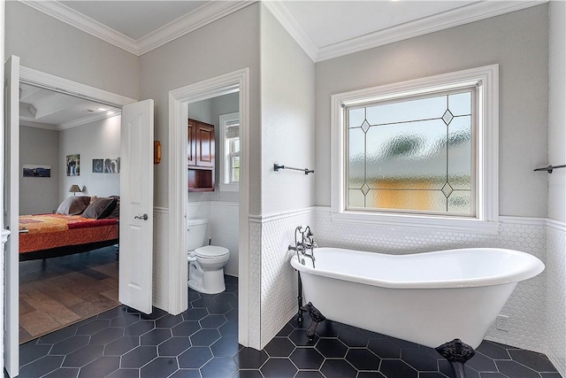 11 Darian Dr, Bentonville, AR 72712 - bathroom featuring tile walls, a wainscoted wall, a soaking tub, connected bathroom, and tile patterned floors