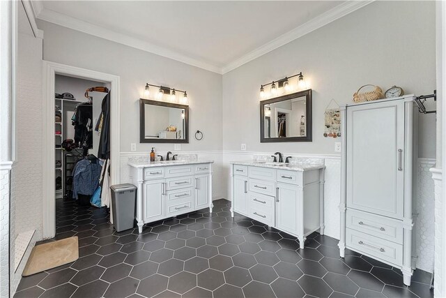 11 Darian Dr, Bentonville, AR 72712 - bathroom with crown molding, a wainscoted wall, two vanities, a walk in closet, and tile patterned flooring