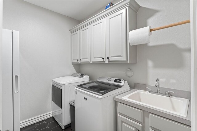 11 Darian Dr, Bentonville, AR 72712 - laundry room featuring separate washer and dryer, cabinet space, and dark tile patterned floors