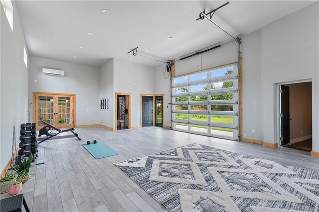 11 Darian Dr, Bentonville, AR 72712 - exercise room featuring a high ceiling, an AC wall unit, french doors, wood finished floors, and recessed lighting