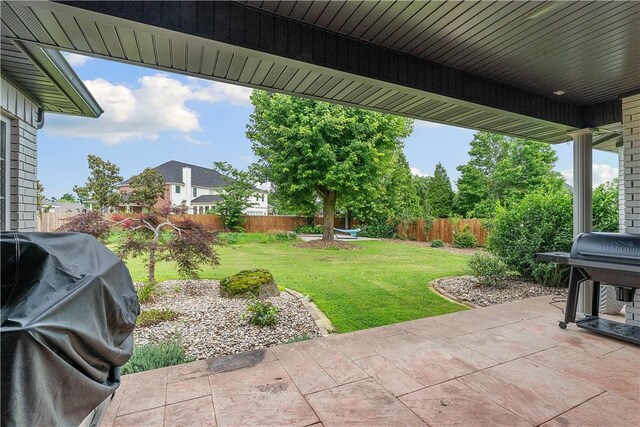 11 Darian Dr, Bentonville, AR 72712 - fenced backyard featuring area for grilling and a patio area