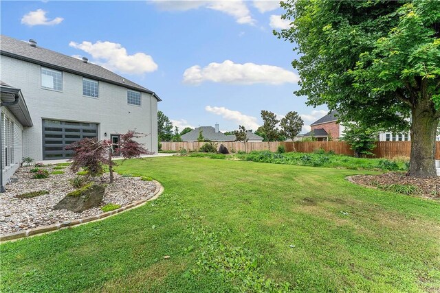 11 Darian Dr, Bentonville, AR 72712 - fenced yard with a garage