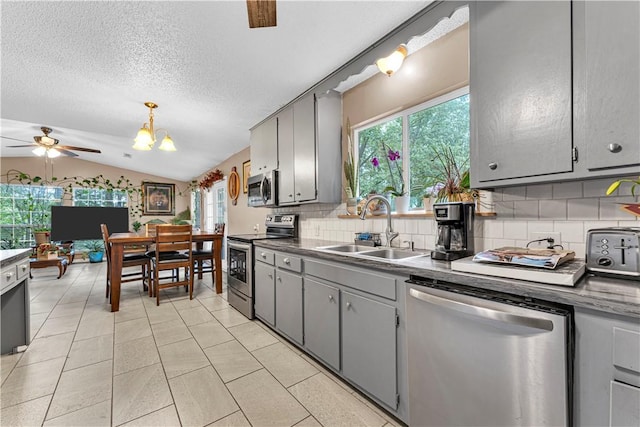 594 Madison 8650, Huntsville, AR 72740 - kitchen with appliances with stainless steel finishes, gray cabinets, decorative backsplash, a ceiling fan, and lofted ceiling