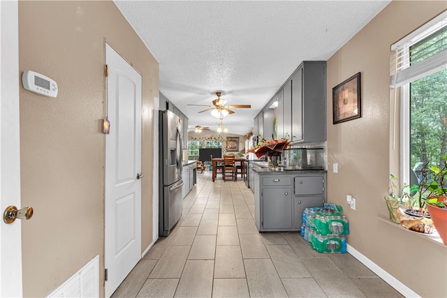 594 Madison 8650, Huntsville, AR 72740 - kitchen with stainless steel fridge, gray cabinets, ceiling fan, dark countertops, and a textured ceiling