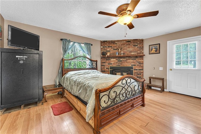 594 Madison 8650, Huntsville, AR 72740 - bedroom with multiple windows, light wood-type flooring, a textured ceiling, and a ceiling fan