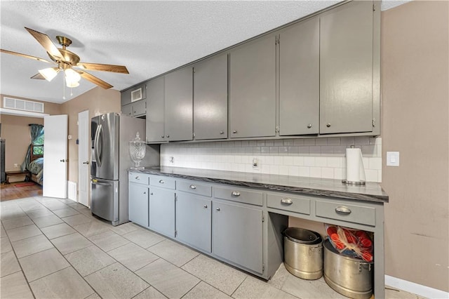 594 Madison 8650, Huntsville, AR 72740 - kitchen featuring dark countertops, gray cabinetry, tasteful backsplash, and a textured ceiling