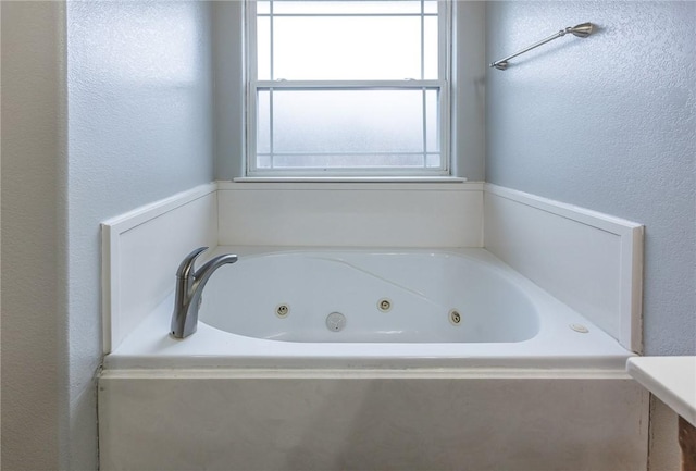 4506 Cory St, Springdale, AR 72762 - bathroom featuring a whirlpool tub and a textured wall