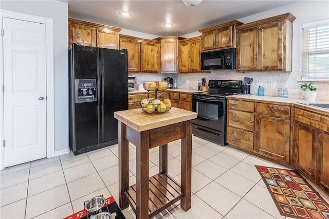 4506 Cory St, Springdale, AR 72762 - kitchen featuring black appliances, light countertops, decorative backsplash, light tile patterned flooring, and recessed lighting