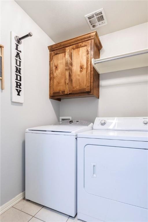 4506 Cory St, Springdale, AR 72762 - laundry room with cabinet space, washing machine and dryer, and light tile patterned floors