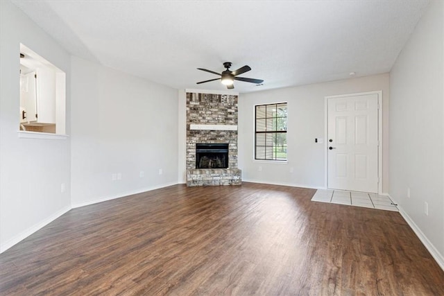 1766 Green Acres Cir, Springdale, AR 72764 - unfurnished living room featuring a ceiling fan, wood finished floors, and a fireplace
