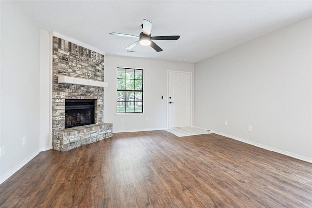 1766 Green Acres Cir, Springdale, AR 72764 - unfurnished living room featuring wood finished floors, ceiling fan, and a large fireplace