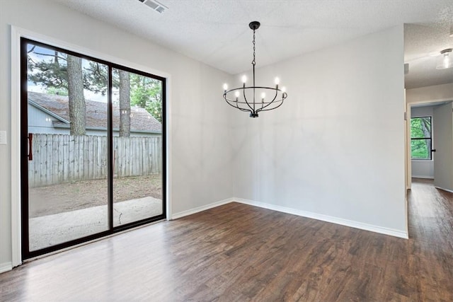1766 Green Acres Cir, Springdale, AR 72764 - unfurnished dining area featuring wood finished floors, a chandelier, plenty of natural light, and a textured ceiling