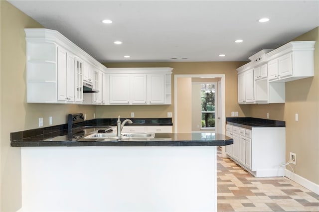 4465 Warwick Cv, Springdale, AR 72762 - kitchen with open shelves, a peninsula, under cabinet range hood, dark countertops, and light floors