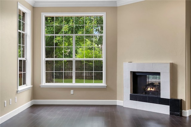 4465 Warwick Cv, Springdale, AR 72762 - unfurnished living room with healthy amount of natural light, dark wood-type flooring, ornamental molding, and a tile fireplace