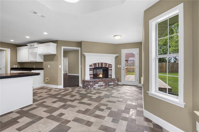 4465 Warwick Cv, Springdale, AR 72762 - unfurnished living room featuring recessed lighting and a brick fireplace