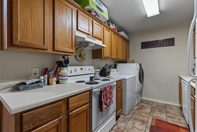 256/258 Graystone Cir, Centerton, AR 72719 - kitchen with white appliances, under cabinet range hood, brown cabinets, and independent washer and dryer