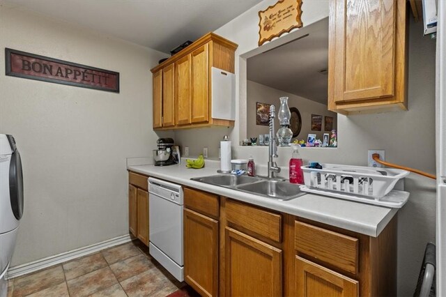 256/258 Graystone Cir, Centerton, AR 72719 - kitchen with white dishwasher, washer / dryer, light countertops, brown cabinets, and light tile patterned floors
