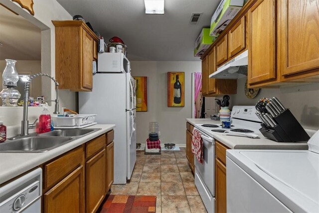 256/258 Graystone Cir, Centerton, AR 72719 - kitchen with white appliances, under cabinet range hood, washer / clothes dryer, and brown cabinetry