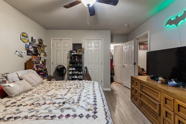 256/258 Graystone Cir, Centerton, AR 72719 - bedroom featuring light wood-style flooring, two closets, and ceiling fan