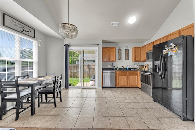 389 Cascade Cir, Springdale, AR 72764 - kitchen featuring stainless steel appliances, lofted ceiling, a chandelier, dark countertops, and light tile patterned flooring