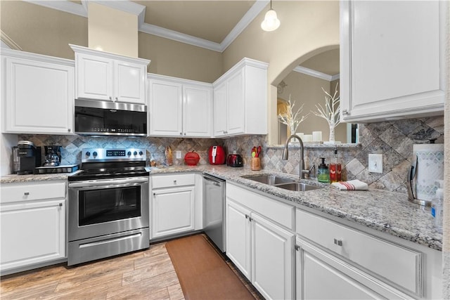 203 Crawford St, Pea Ridge, AR 72751 - kitchen featuring appliances with stainless steel finishes, crown molding, white cabinetry, light wood-type flooring, and decorative backsplash