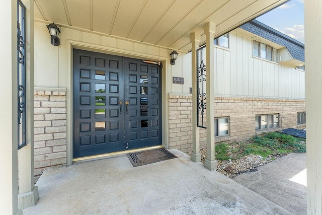 16841 Heritage Bay Rd Unit E-4, Rogers, AR 72756 - entrance to property featuring brick siding, board and batten siding, and a garage