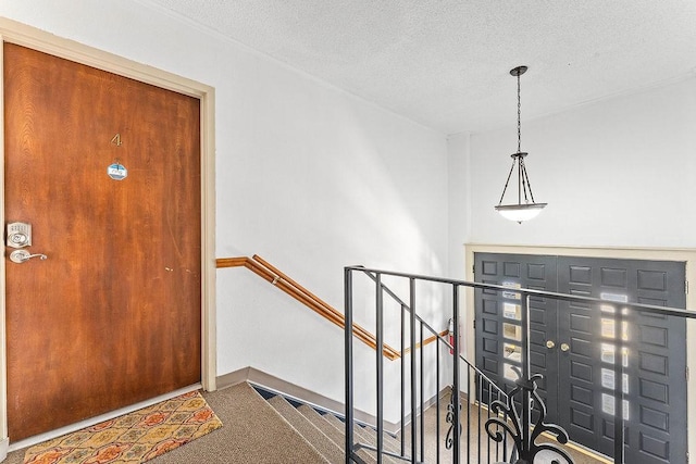 16841 Heritage Bay Rd Unit E-4, Rogers, AR 72756 - foyer with carpet flooring and a textured ceiling